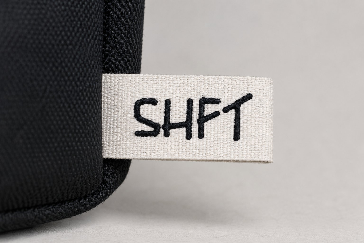 SHFT logo embroidered onto the bag's woven tag